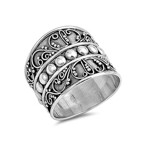 Chunky silver bohemian Bali ring with an oxidised finish. The ring is decorated with delicate swirl like designs and a band of large silver dots positioned across the centre of the ring.