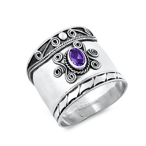 Chunky silver bohemian Bali ring with an oxidised finish. Embellished with a purple cubic zirconia stone and detailed with silver rope and swirl designs.