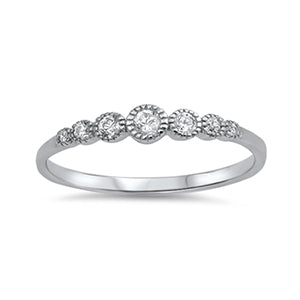 Delicate silver ring embellished with seven round cut clear cubic zirconia stones. The largest stone sits in the centre of the band, and each stone either side becomes gradually smaller than the last.